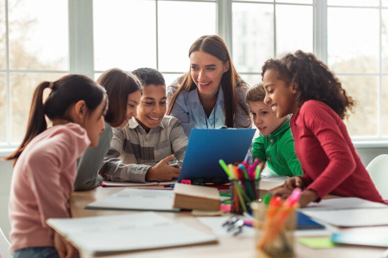 teacher engaging with group of students in classroom